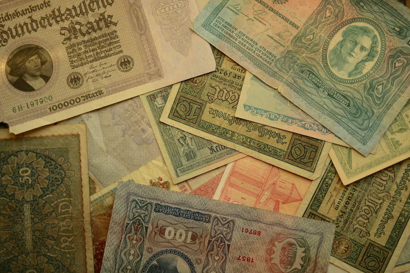A pile of old banknotes from different countries